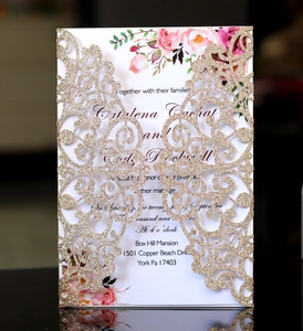 Detailed laser-cut floral wedding invitation card with gold glitter finish on white paper