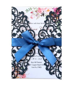 Blue glitter laser cut wedding invitation with satin bow and floral inner card