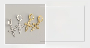 Detail view of S925 sterling silver cross earrings with zircon pavé in gold and silver