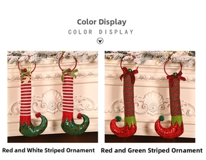 Detail of Christmas elf legs with bells and bows hanging on a festive mantelpiece