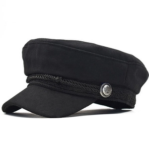 Detail view of black wool fiddler cap with woven rope trim and vintage metal button