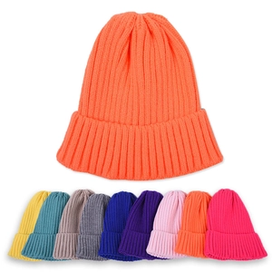 Colorful knitted beanies for children in various candy colors with ribbed texture