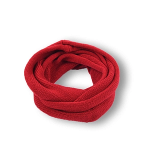 Detail of red knitted infinity scarf showing fine weave texture on white background