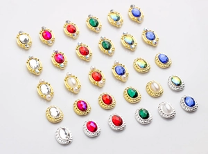 Detailed grid view of oval alloy nail charms with vibrant crystals and pearls