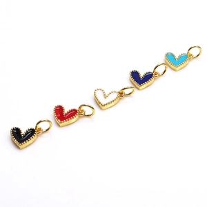 Detail of five colorful enamel heart charms in gold metal finish for DIY jewelry making