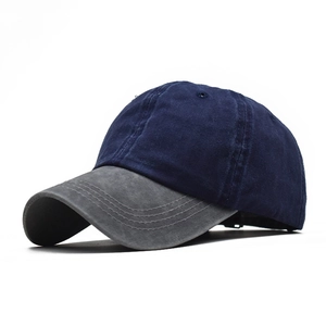 Detail view of contrast baseball cap showing navy blue crown and grey washed cotton brim