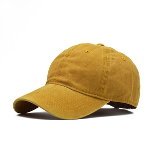 Detail view of mustard yellow washed cotton baseball cap with premium stitching texture