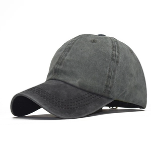 Detail of dark grey washed cotton baseball cap with six-panel stitching and curved brim