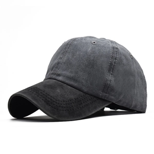 Detail view of washed dark grey cotton baseball cap with ventilation holes and stitched brim