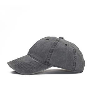 Detail view of washed cotton baseball cap in charcoal grey with vintage worn texture