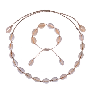 Detailed view of handmade Bohemian shell necklace and bracelet set with cowrie shells