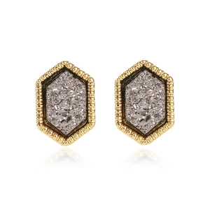 Macro view of hexagonal gold studs with sparkling gray crystal inlay and fine texture
