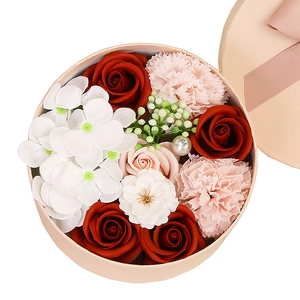 Pink round gift box with red roses and white soap flowers for Valentine's Day gifts