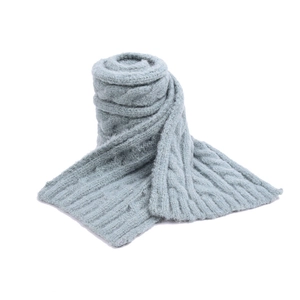 Detail of light blue knit scarf featuring thick cable stitch and soft wool texture