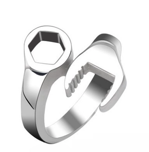 Detailed view of silver wrench-shaped steel ring with mirror-polished finish and open design
