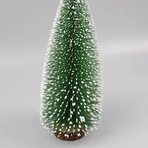 Detail of green sisal Christmas tree with white snow frosting and wooden base