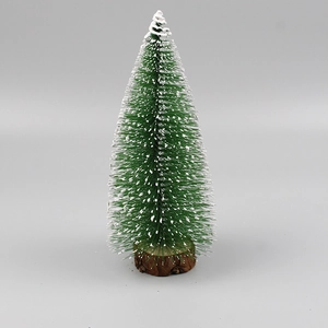 Close-up of a mini green sisal Christmas tree with white snow flocking and round wood base