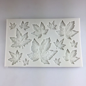 DIY silicone mold for maple leaf fondant decorations with various sizes on white background