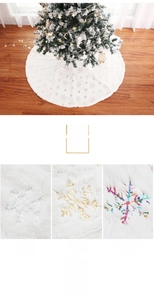 Detail of white plush Christmas tree skirt featuring sparkling sequin snowflake embroidery