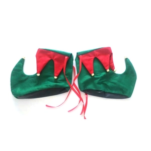 Detail of red and green Christmas elf shoe covers with gold bells for holiday parties