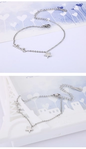 Close-up of silver-toned star and Lucky charm bracelet with lobster clasp and extender