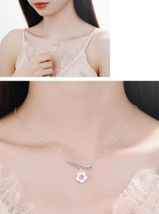 Detail view and model wearing a minimalist silver cherry blossom pendant with pink gemstone