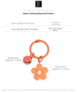 Macro detail of orange clay flower charm with 1.5cm bell and 2.5cm petal pendant