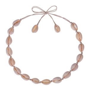 Detail of handmade natural cowrie shell choker with woven brown cord and tie closure