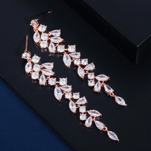 Elegant rose gold leaf tassel earrings with sparkling zircon crystals on reflective background
