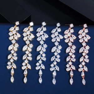 Detailed trio of petal drop tassel earrings in gold, silver, and rose gold with zircon stones