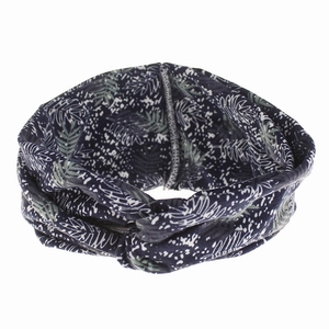 Detail of bohemian headband with tropical green leaf print and knot design
