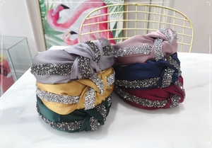 Detail of colorful knotted headbands featuring sparkling rhinestones and satin fabric texture