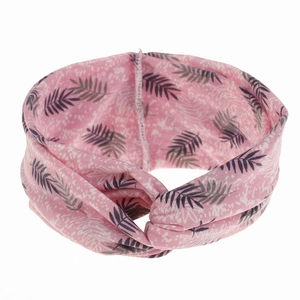 Detail of pink knotted headband with dark gray tropical palm leaf prints on soft fabric