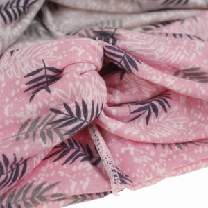 Close-up of pink fabric headband with leaf print showing knit texture and twisted knot