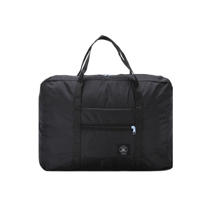 Close-up of black waterproof foldable travel bag showing the logo and nylon material