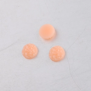 Macro detail of 8mm pink resin druzy rhinestones with sparkling textured finish