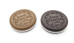 Close-up of portable round chocolate cookie-shaped mirrors and hair combs in two colors