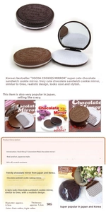 Detailed view of chocolate cookie shaped folding mirror with internal comb and cocoa relief