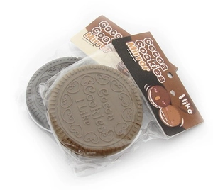 Close-up of mini chocolate cookie pocket mirror with heart pattern and comb details