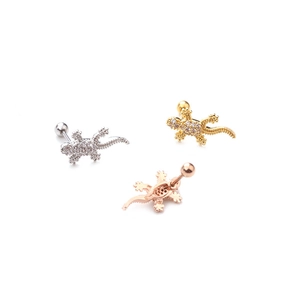 Three lizard stud earrings in silver, gold, and rose gold with pavé-set stones on white background