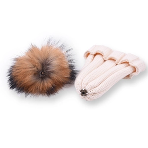 Winter knit baby beanie in cream white with a large detachable faux fur pompom ball