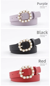 Detailed view of pearl-embellished round gold buckles on purple, black, and red leather belts