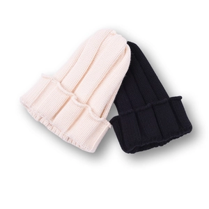 Detailed view of children's ribbed knitted winter beanies in cream and black
