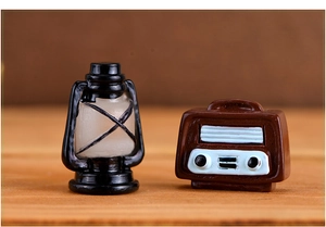 Macro detail of miniature vintage resin lantern and radio ornaments for retro home decor