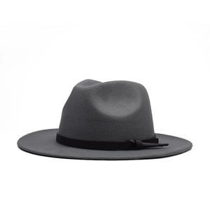 Detail of a dark grey wool fedora hat featuring a flat brim and a black decorative band