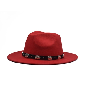 Detail of red wool fedora hat featuring a black leather band with silver metal studs