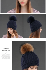 Close-up of thick cable knit texture and large fluffy pom-pom on women's winter hat