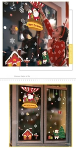 Detailed Christmas window stickers showing Santa and reindeer on glass display