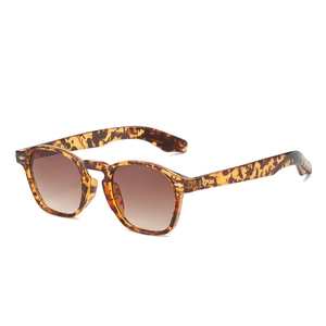 Retro tortoise shell sunglasses with brown gradient lenses and metal rivet details