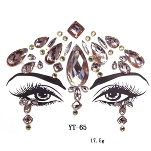 Close-up of amber champagne acrylic face gems in teardrop and oval shapes for forehead